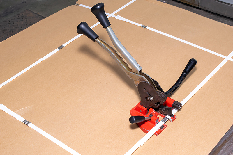 manual strapping of packages for shipping