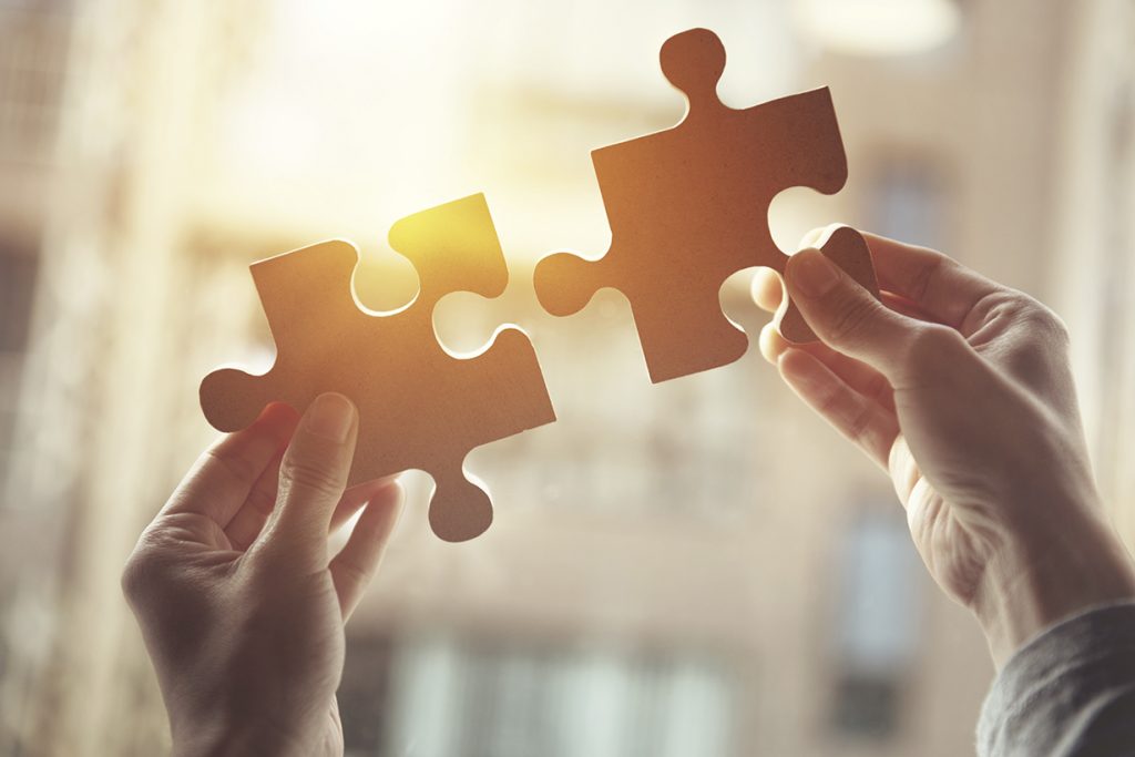 Businesswoman hand connecting jigsaw puzzle