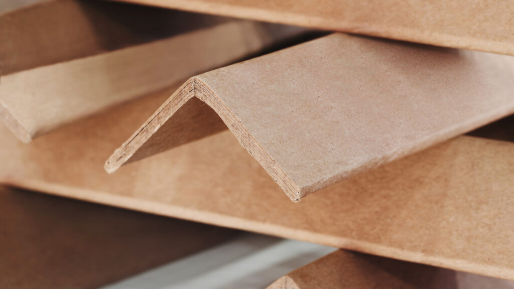 Stack of cardboard corner protectors for packaging, corners are brown and arranged in a row as background templates of pages and banners of delivery logistics concept